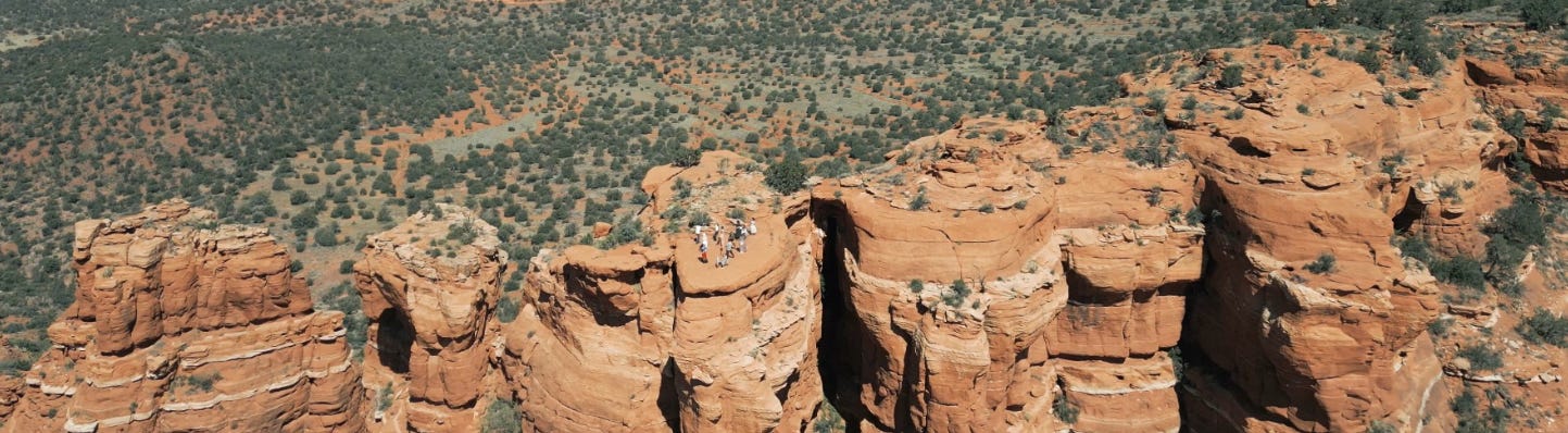 A large rock formation with trees in the background

Description automatically generated