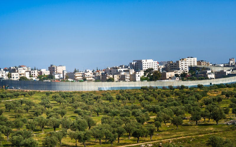Israeli security fence near Jerusalem separating territory.