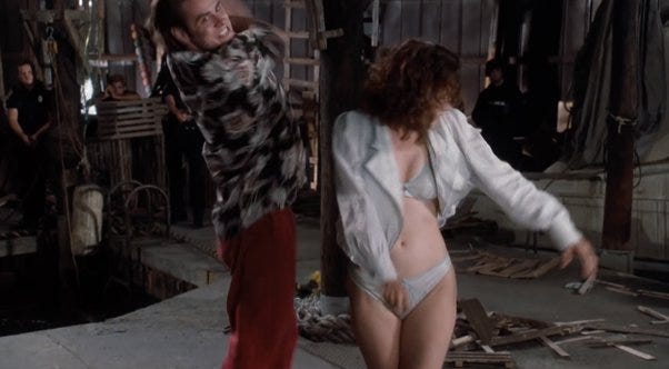 A scene from Ace Ventura 1, where the antagonist has been stripped down to her underwear.