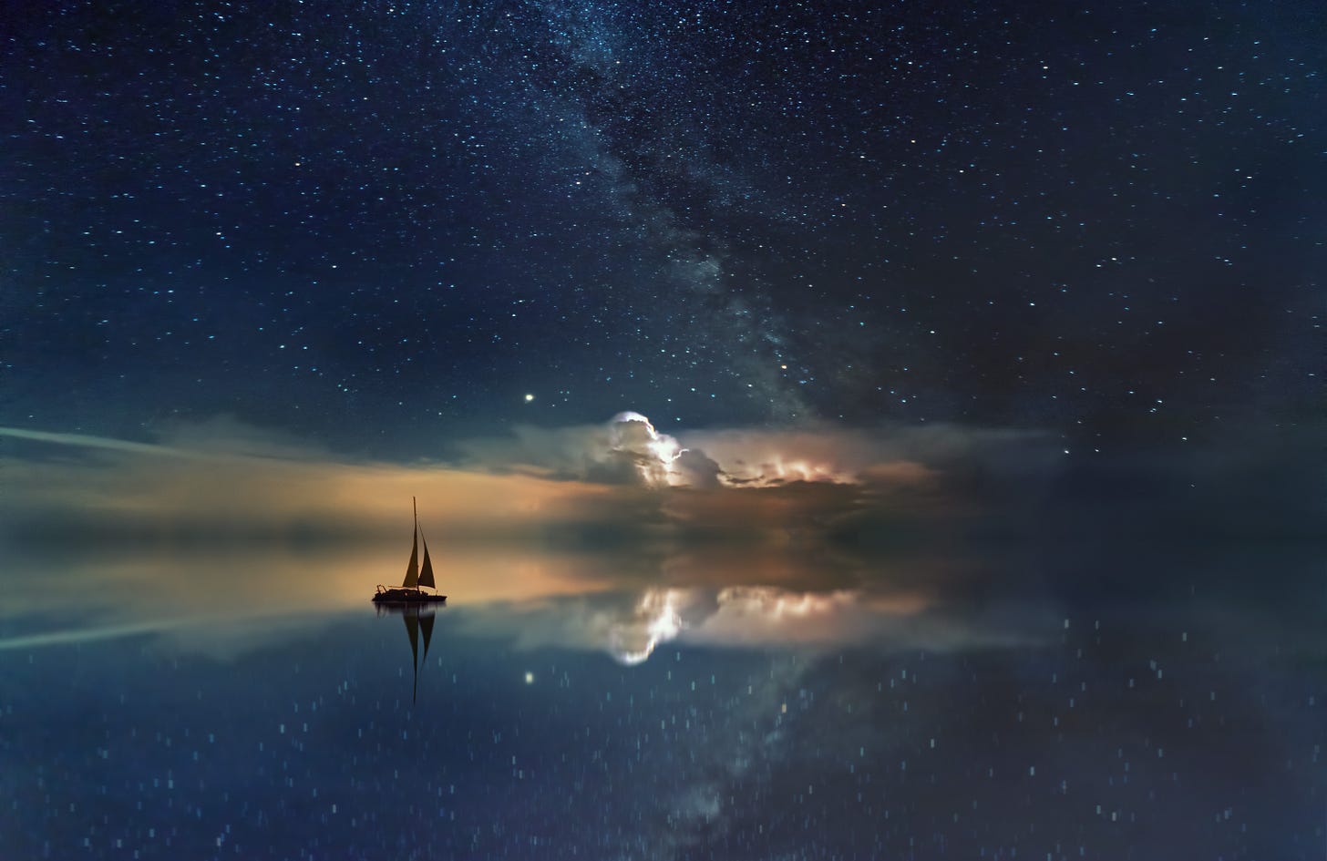 A sailboat on a perfectly flat ocean seen against a galaxy of stars and some clouds.