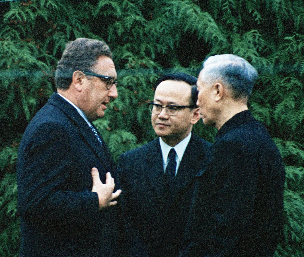 Photo of U.S. presidential advisor Dr. Henry Kissinger, left, and Le Duc Tho, right, North Vietnam's chief negotiator, are seen at Gif-sur-Yvette, suburban Paris, just before the beginning of secret talks, Nov. 23, 1972. At center is Nguyen Phuong, a member of the North Vietnamese delegation. (AP Photo/Michel Lipchitz)