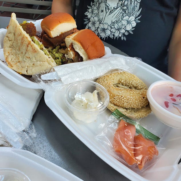 A Styrofoam container full of Jewish food.