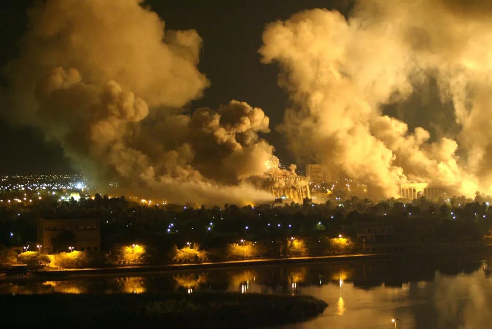 Smoke covers the presidential palace compound in Baghdad 21 March 2003 during a massive US-led air raid on the Iraqi capital. Smoke billowed from a number of targeted sites, including one of President Saddam Hussein's palaces, an AFP correspondent said.     AFP PHOTO/Ramzi HAIDAR (Photo credit should read RAMZI HAIDAR/AFP via Getty Images)