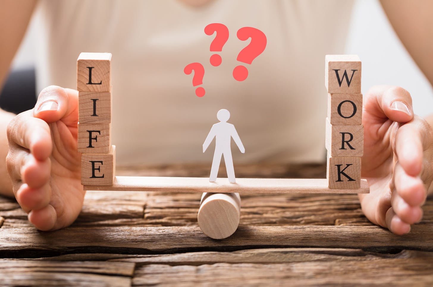 Life and work balanced on a seesaw with a person in the center with question marks above their head.