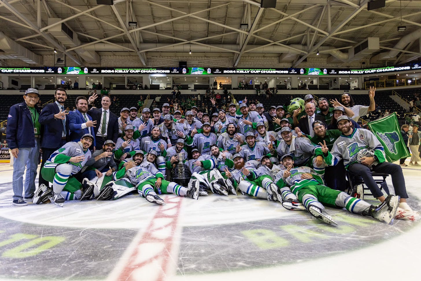 The Florida Everblades players, coaches, and executives post with the Kelly Cup after winning the championship.