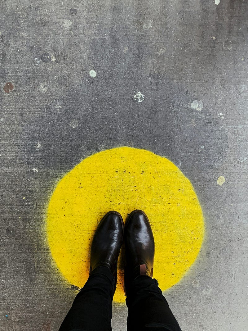 a person standing on a yellow circle