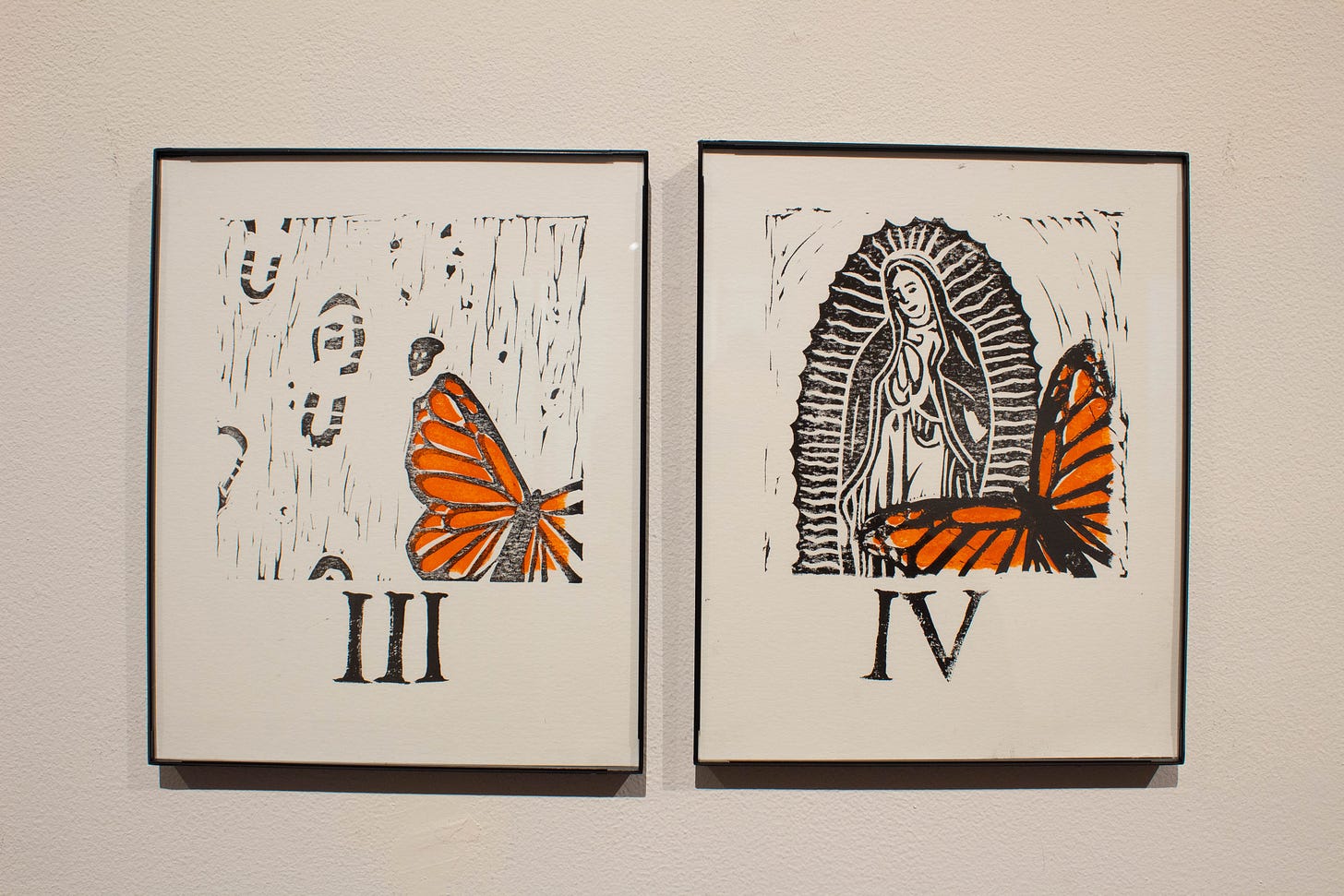 Two framed prints on a wall. One shoes footprints with a fallen monarch butterfly on the path. The second shows a Virgin Mary figure with the butterfly landing on it.