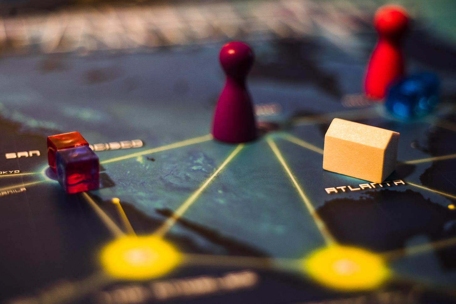 The board game Pandemic. There are disease cubes on San Francisco, a research station on Atlanta, and a player pawn is visible.