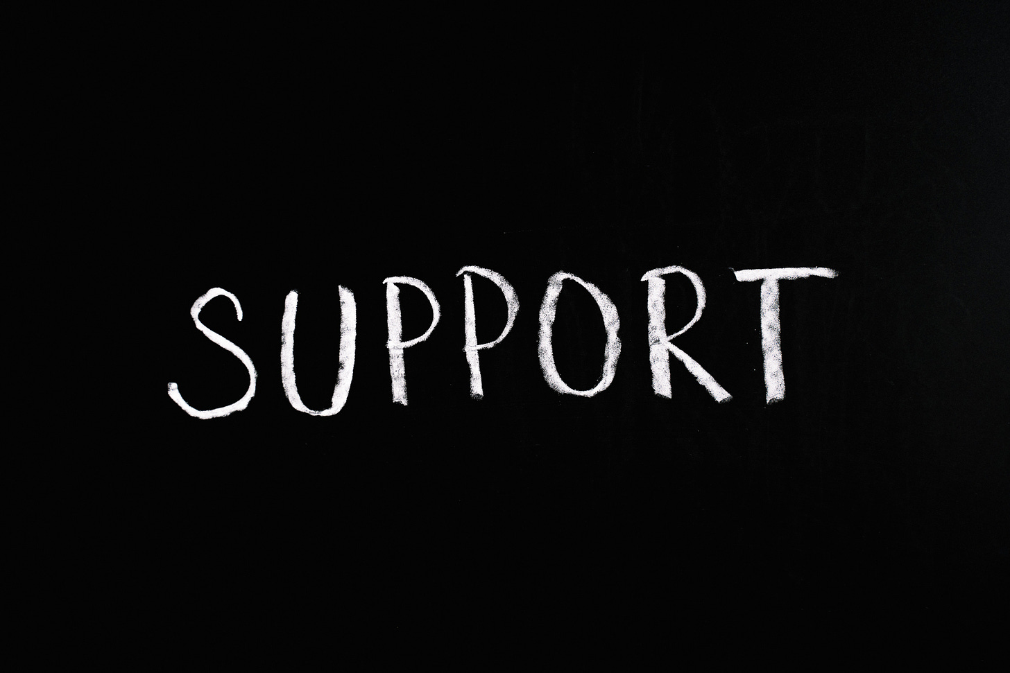 the word support written in white chalk on a black background