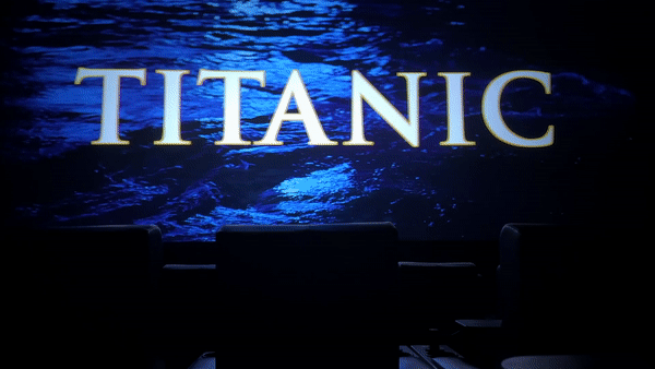 GIF of TITANIC text over dark water in a dark movie theater.