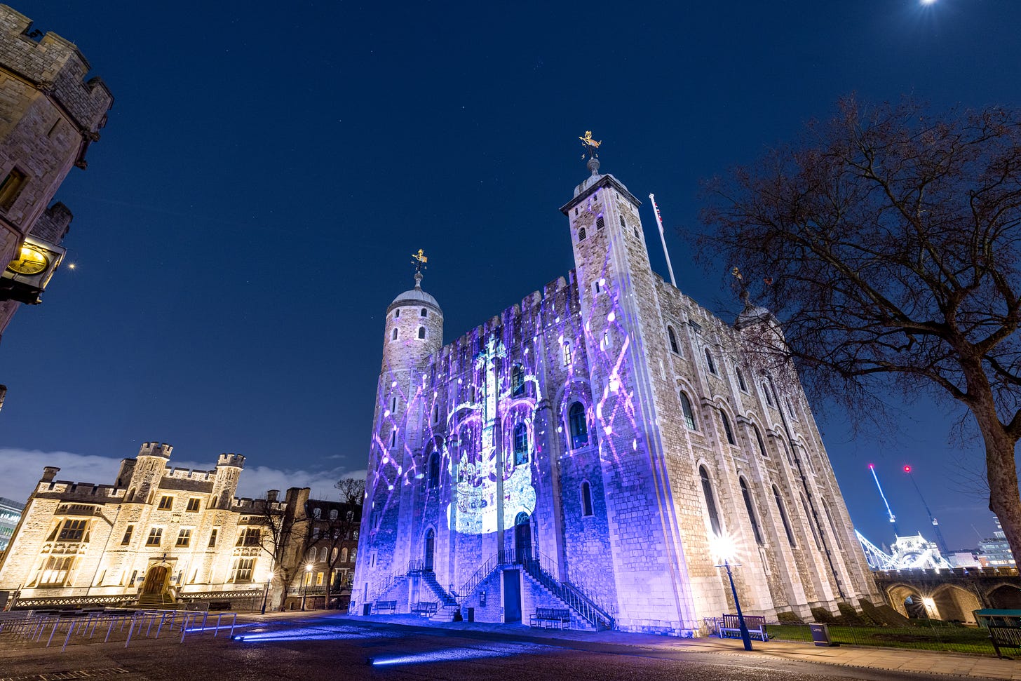Illuminated Tower of London at night with projection of crown on facde