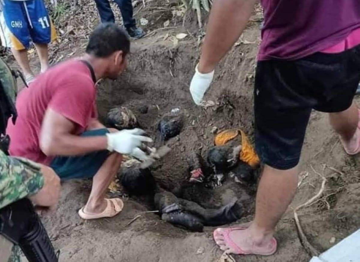 Law enforcers recover seven human remains from a shallow grave in a remote area in Sapad, Lanao del Norte. CONTRIBUTED PHOTO