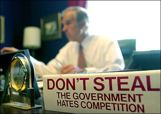 A picture of Ron Paul with the "Don't steal, the government hates competition" sign.
