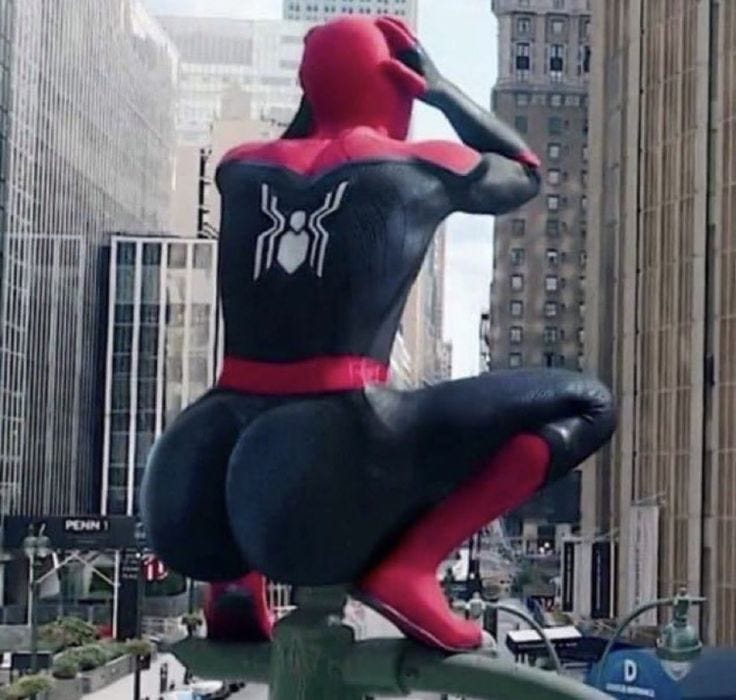 This may contain: a giant spider man statue on top of a pole in the middle of a city