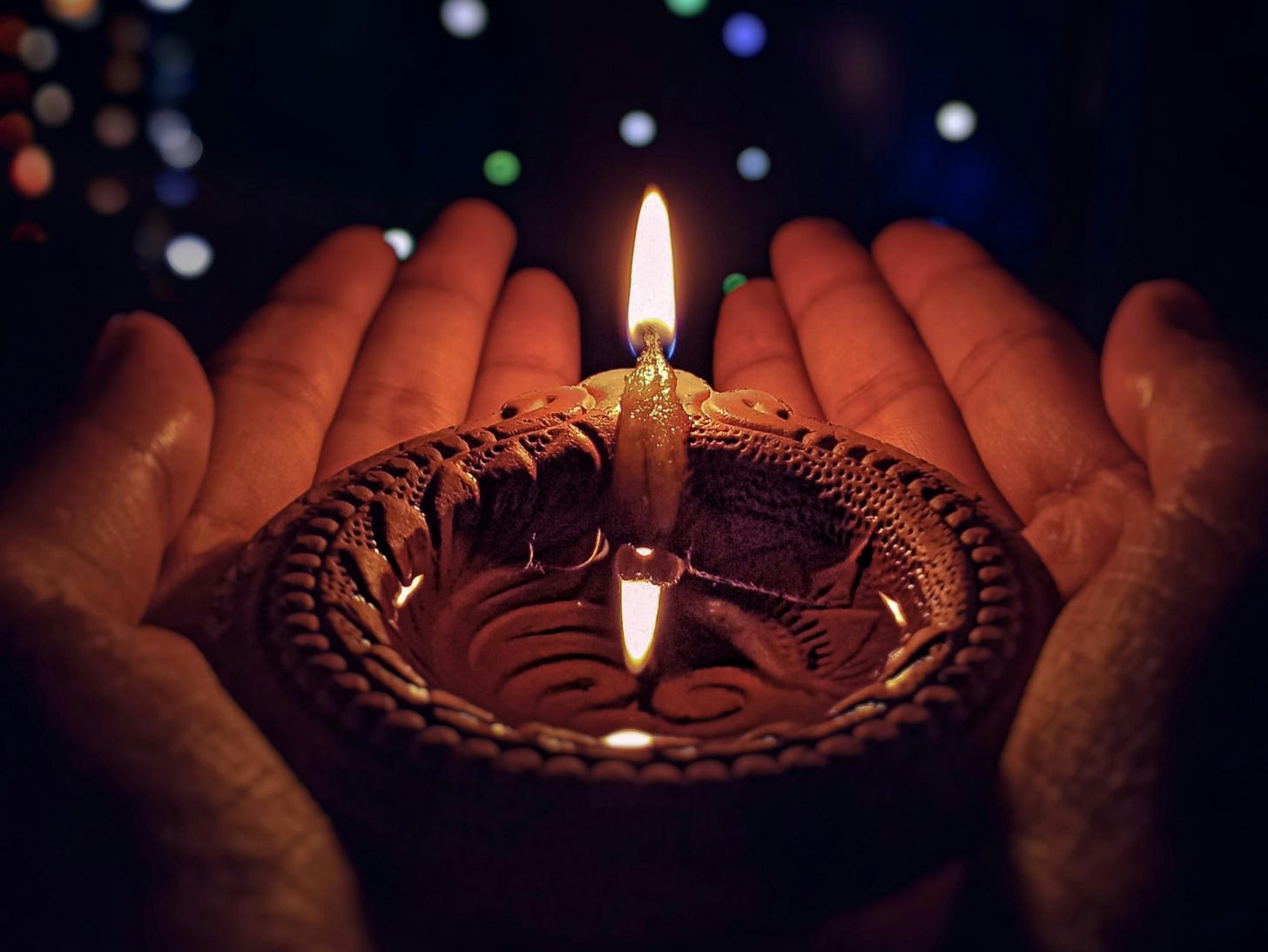 Diwali candle held in two hands