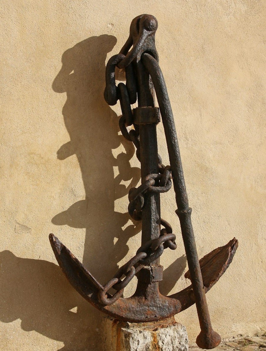 brass anchor near beige wall brass anchor near beige wall