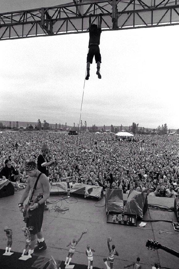 r/OldSchoolCool - Pearl Jam, 1992: Eddie Vedder hanging from the rafters at a free concert in Seattle at the end of their year-long plus "Ten" tour.
