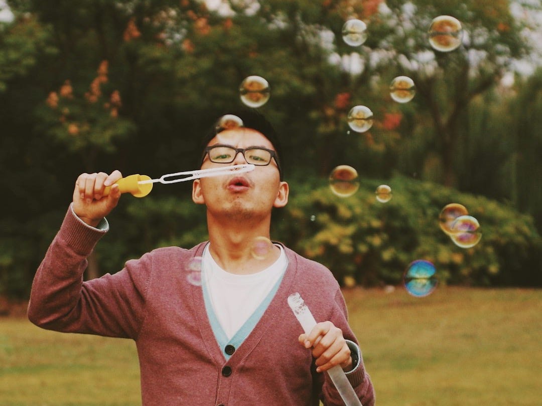 man playing bubbles