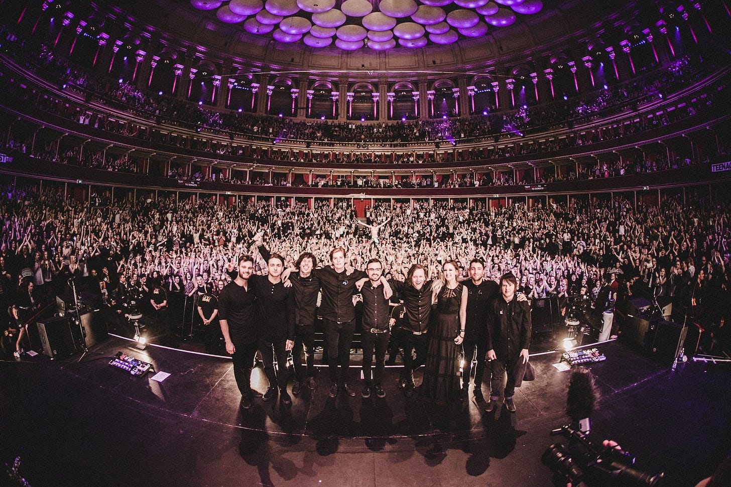 A photo taken from the end of Bring Me The Horizon's gig at Royal Albert Hall with the band arm in arm in front of a jubilant crowd A photo taken from the end of Bring Me The Horizon's gig at Royal Albert Hall with the band arm in arm in front of a jubilant crowd