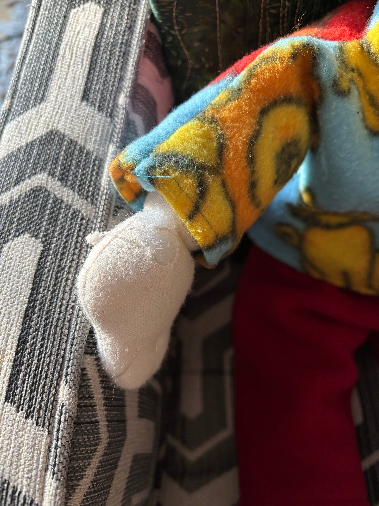 Close up of doll hand with torn spot