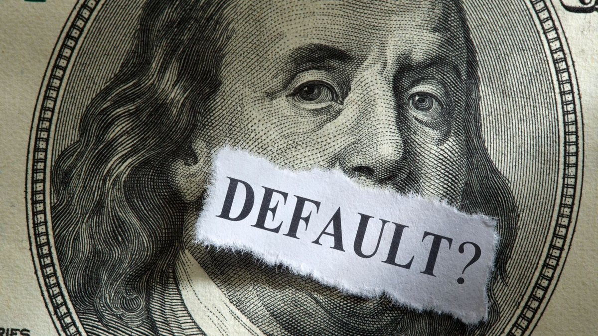 A debt default occurs when a country fails to make scheduled payments on its outstanding debt. 

In the case of the United States, this would mean the government not being able to pay interest or principal on its Treasury bonds, bills, and notes held by investors. 