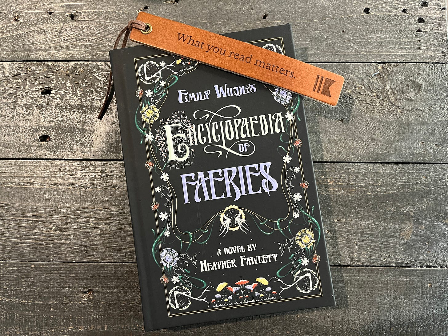 Emily Wilde's Encyclopedia of Fairies by Heather Fawcett, with leather bookmark that says "What you read matters"