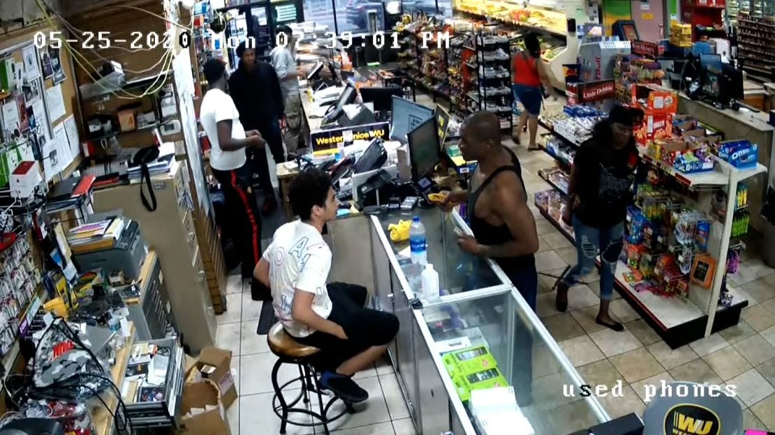 George Floyd is seen at the counter in a black tank top in this surveillance video from Cup Foods before the police were called.