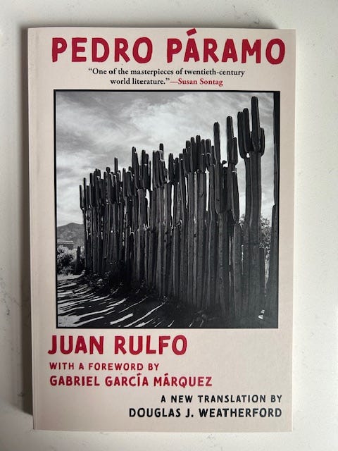 The cover of Pedro Paramo by Juan Rulfo is white with red letters.