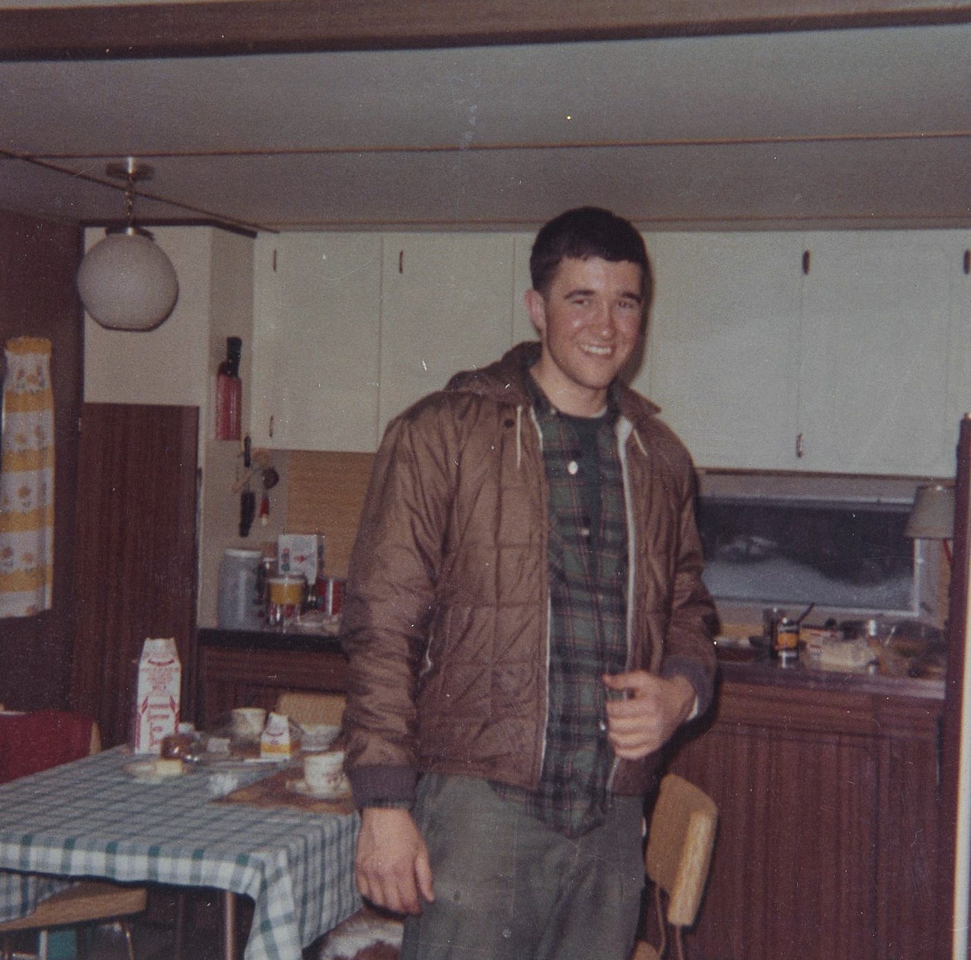 Young man standing inside the kitchen