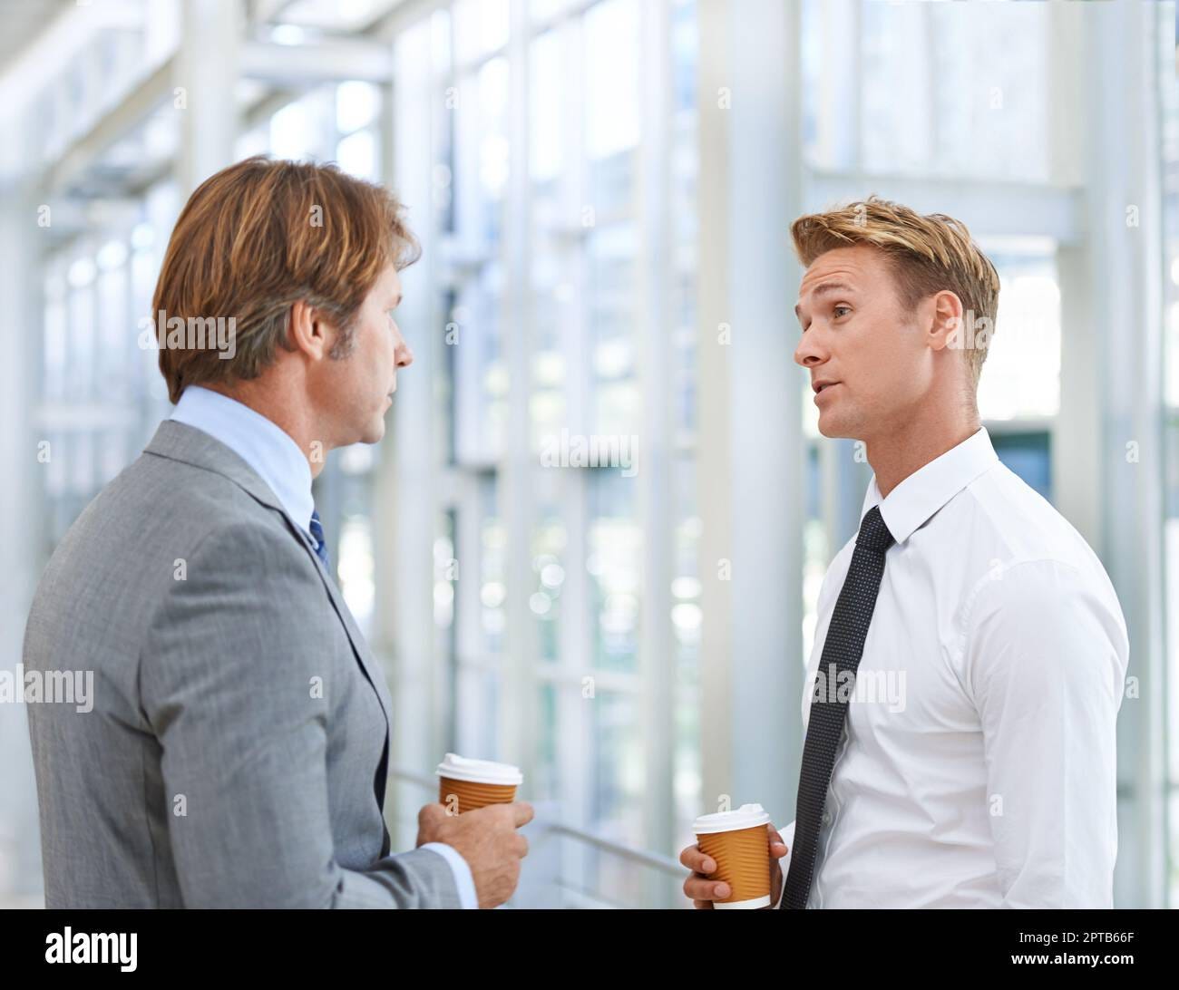 A quick catch-up over some coffee. A cropped image of two businessmen  having coffee and a conversation Stock Photo - Alamy