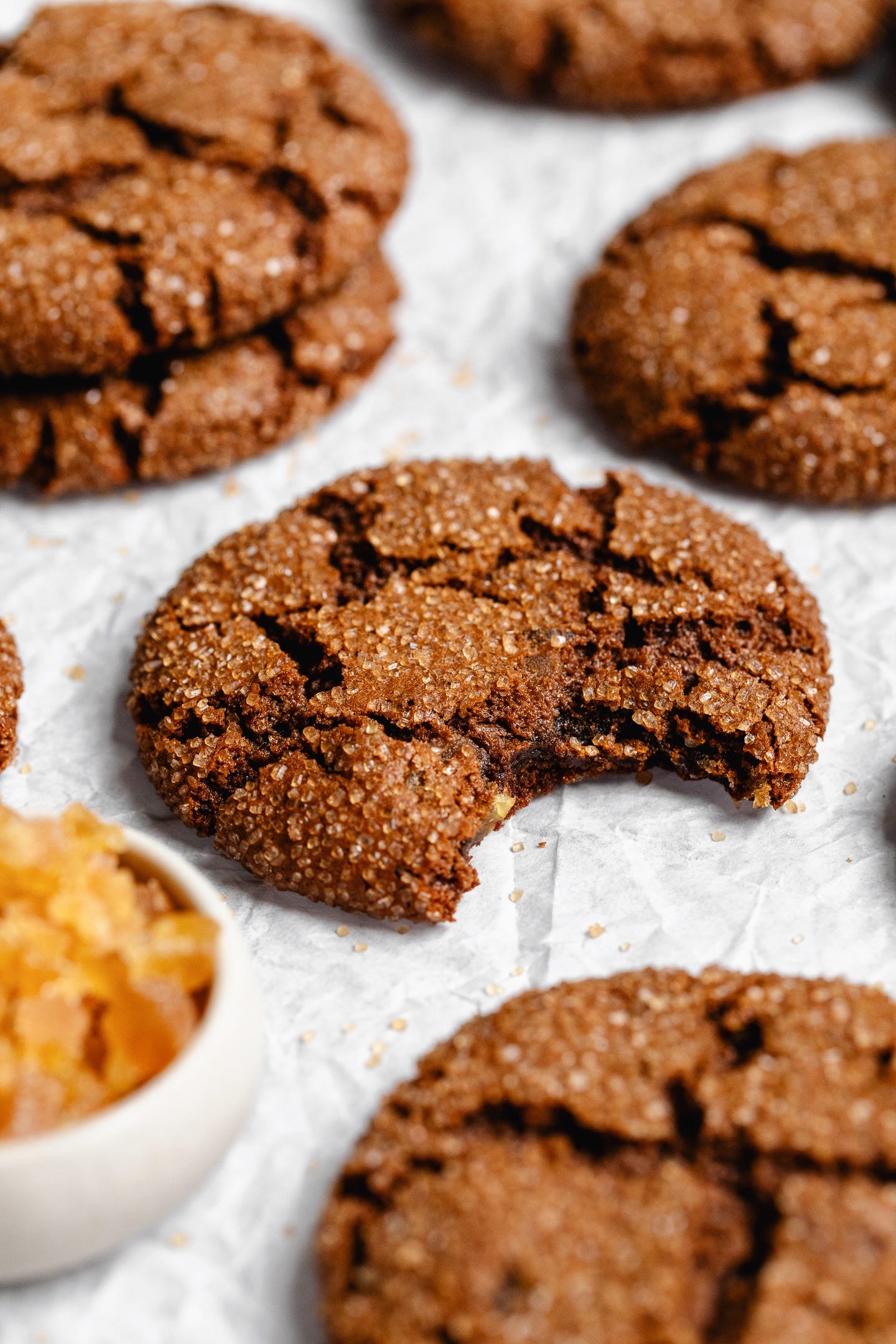 Close up shot of vegan ginger molasses cookie with bite taken out