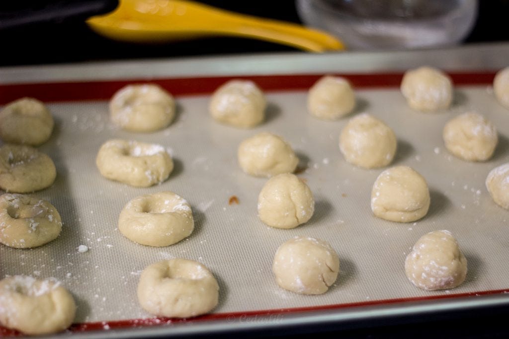 Balls of dough, and some with 'prints' ready for filling. 