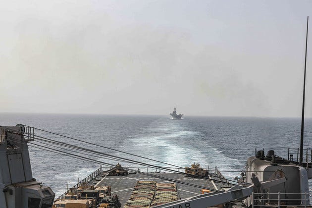 The amphibious dock landing ship USS Carter Hall and amphibious assault ship USS Bataan transit the Bab al-Mandeb strait on Aug. 9, 2023. 