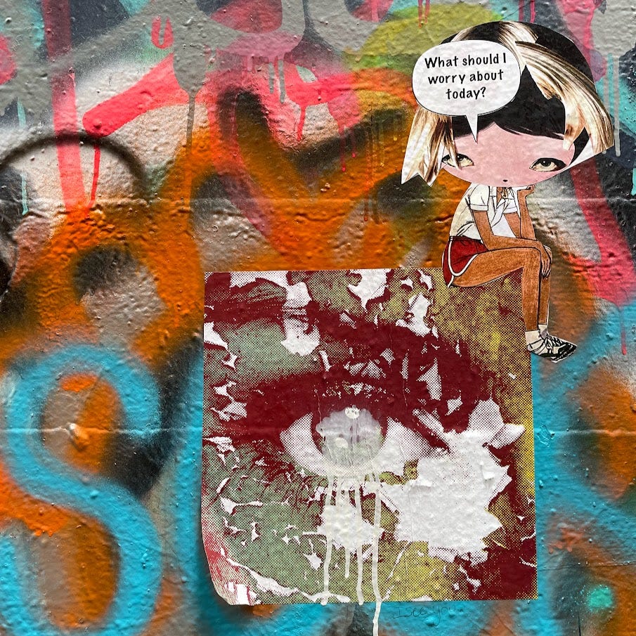 detail shot of graffiti art at an abandoned mill; the central image is a wheatpaste image of an eye in greens and maroons, and a cartoon woman sits atop with accompanied by a text bubble that reads "what should I worry about next?"