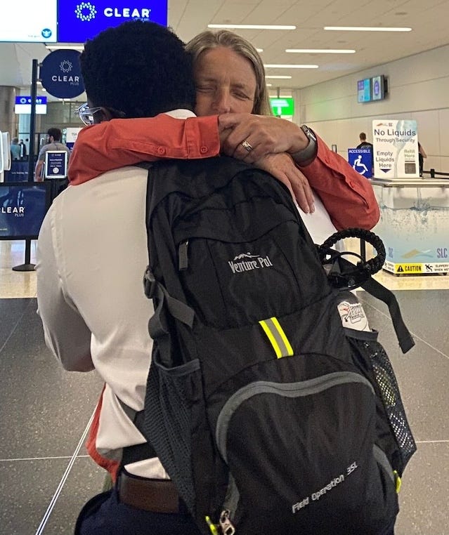 mom and son hug at airport