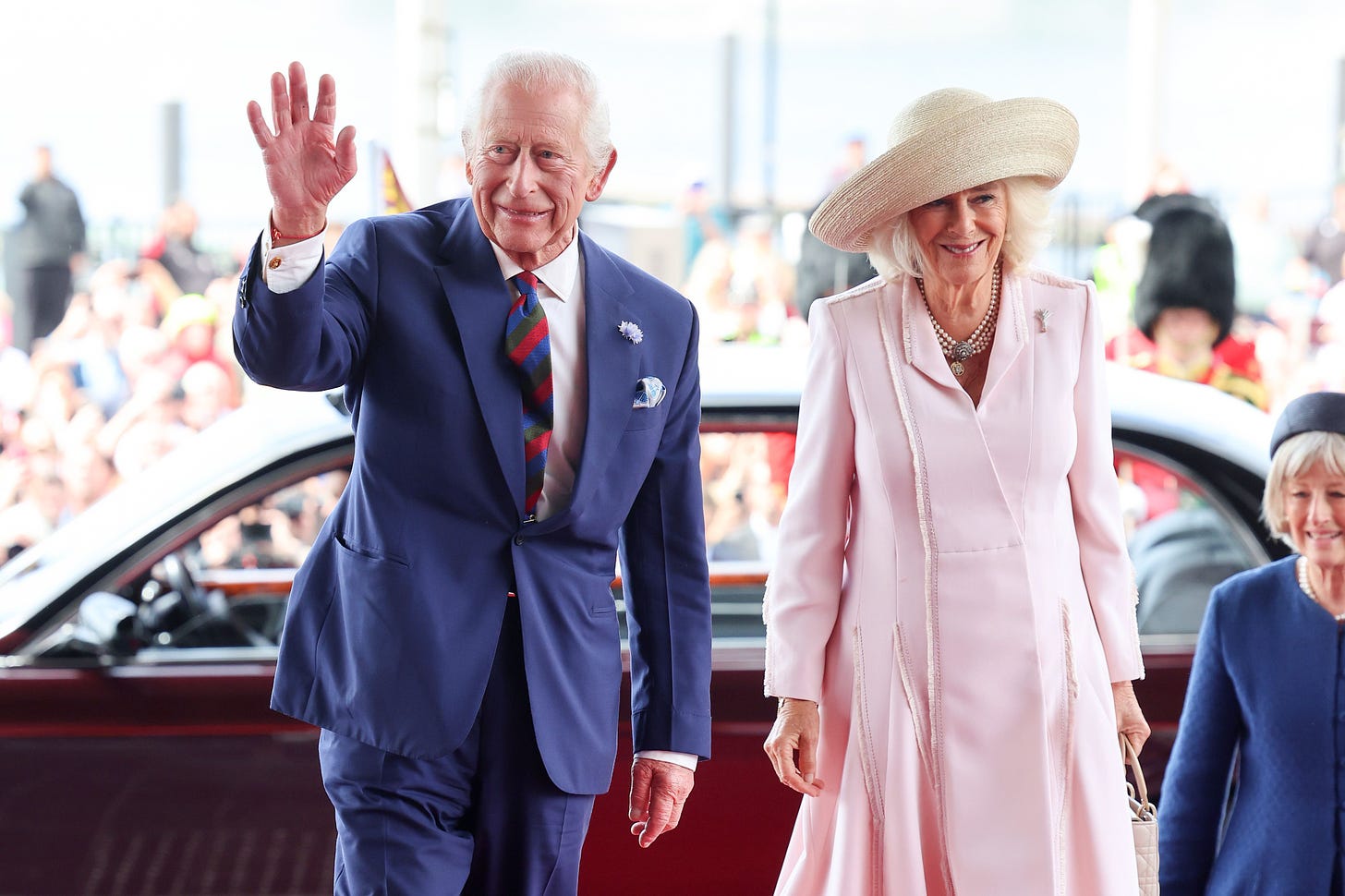 Charles and Camilla wave to crowds in Wales