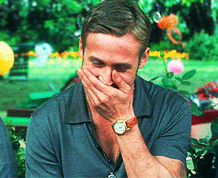 Ryan Gosling laughing with his hand over his mouth