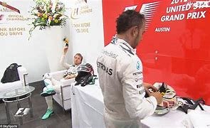Image result for nico rosbergs and lewis hamilton cap throw