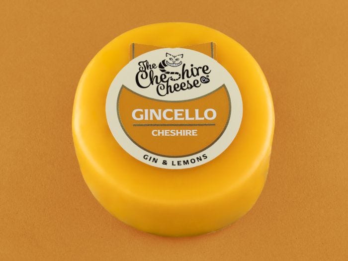 A yellow Gincello - Gin & Lemon Cheshire Cheese - Waxed Truckle 200g