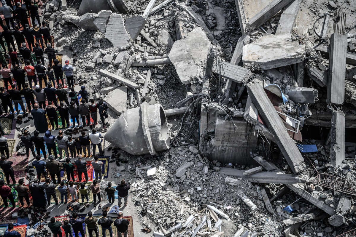 An aerial view of Palestinians performing Friday prayers among the rubble of the Al-Farooq Mosque, destroyed in an Israeli attack, on March 1, 2024, in Rafah, Gaza.