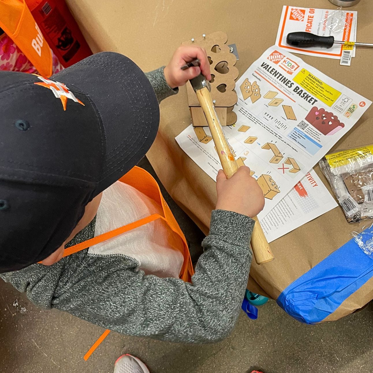 Boy building a valentines basket at the home depot kids workshop Boy building a valentines basket at the home depot kids workshop