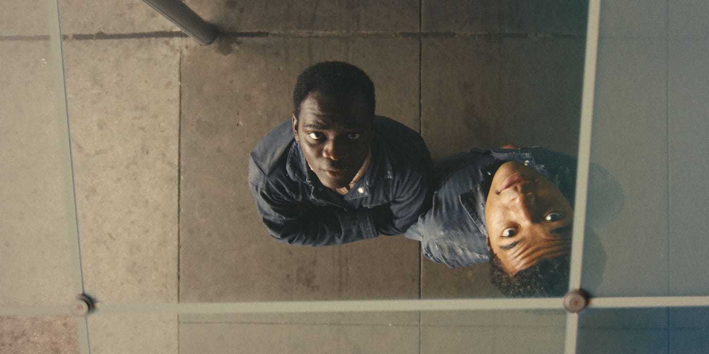 Ethan Herisse and Brandon Wilson look at their reflections in a bus station ceiling in "Nickel Boys" (2024)