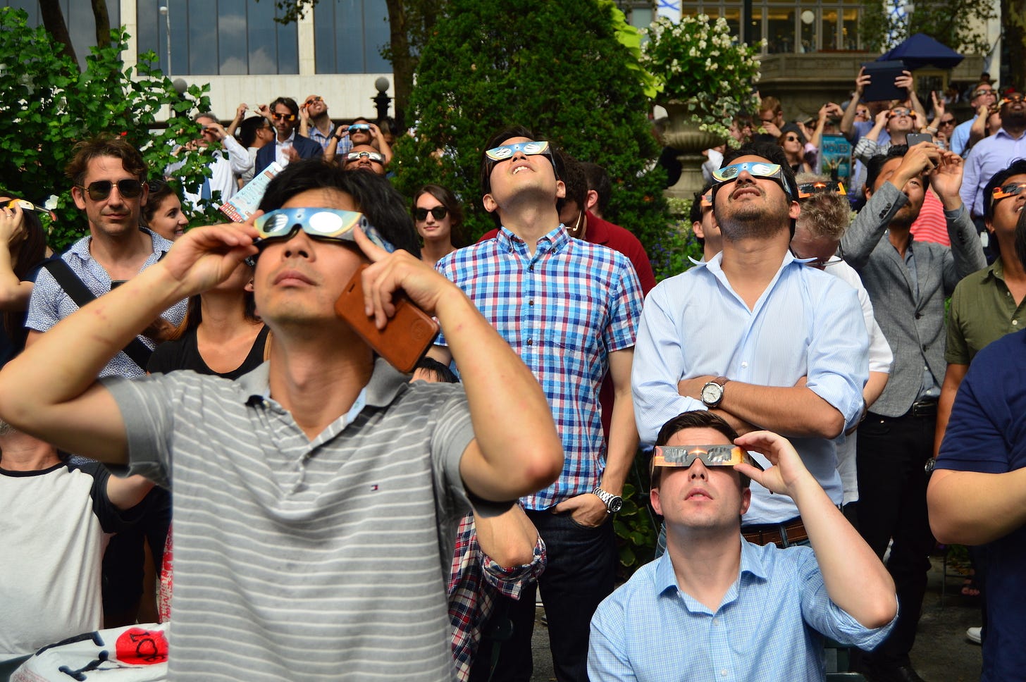 New Yorkers don their solar glasses to view the solar eclipse in Bryant Park in Manhattan