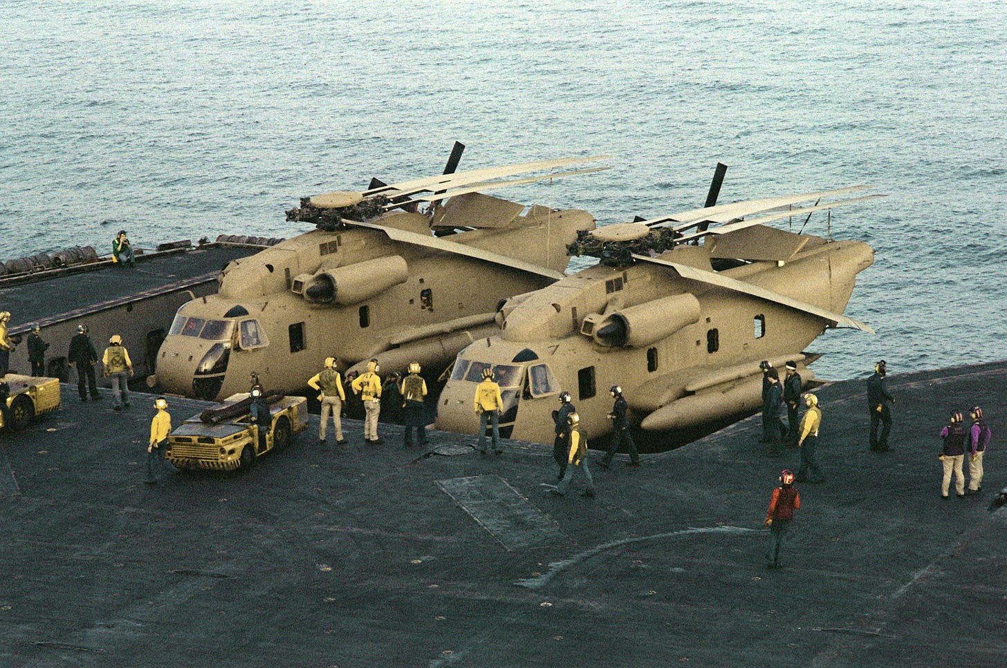 Wikipedia explanation of this picture: Two U.S. Navy Sikorsky RH-53D Sea Stallion helicopters of helicopter mine countermeasures squadron HM-16 Sea Hawks are brought to the flight deck of the aircraft carrier USS Nimitz (CVN-68) during "Operation Evening Light" (Eagle Claw), in the Arabian Sea on 24 April 1980.