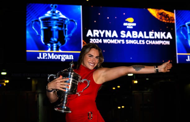 Aryna Sabalenka poses with the champions trophy during the champions trophy shoot after defeating Jessica Pegula of the United States in the singles...