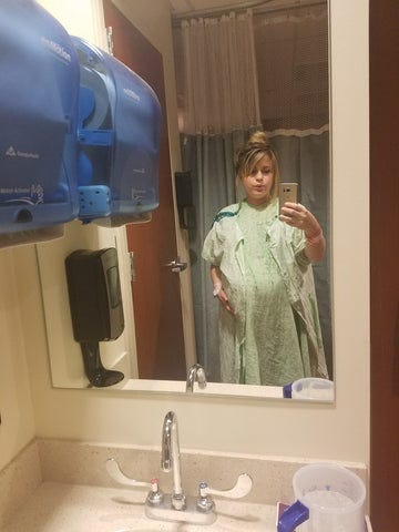 Image of Aubrey holding pregnant belly soon before c-section surgery