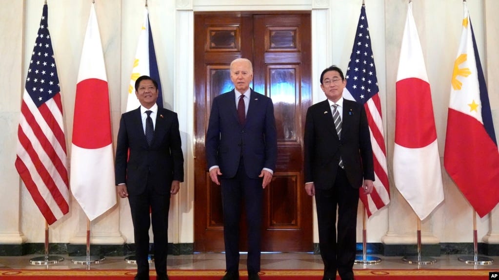 President Joe Biden, center, Philippine President Ferdinand Marcos Jr., left, and Japanese Prime Minister Fumio Kishida pose before a trilateral meeting in the East Room of the White House in Washington, April 11, 2024.