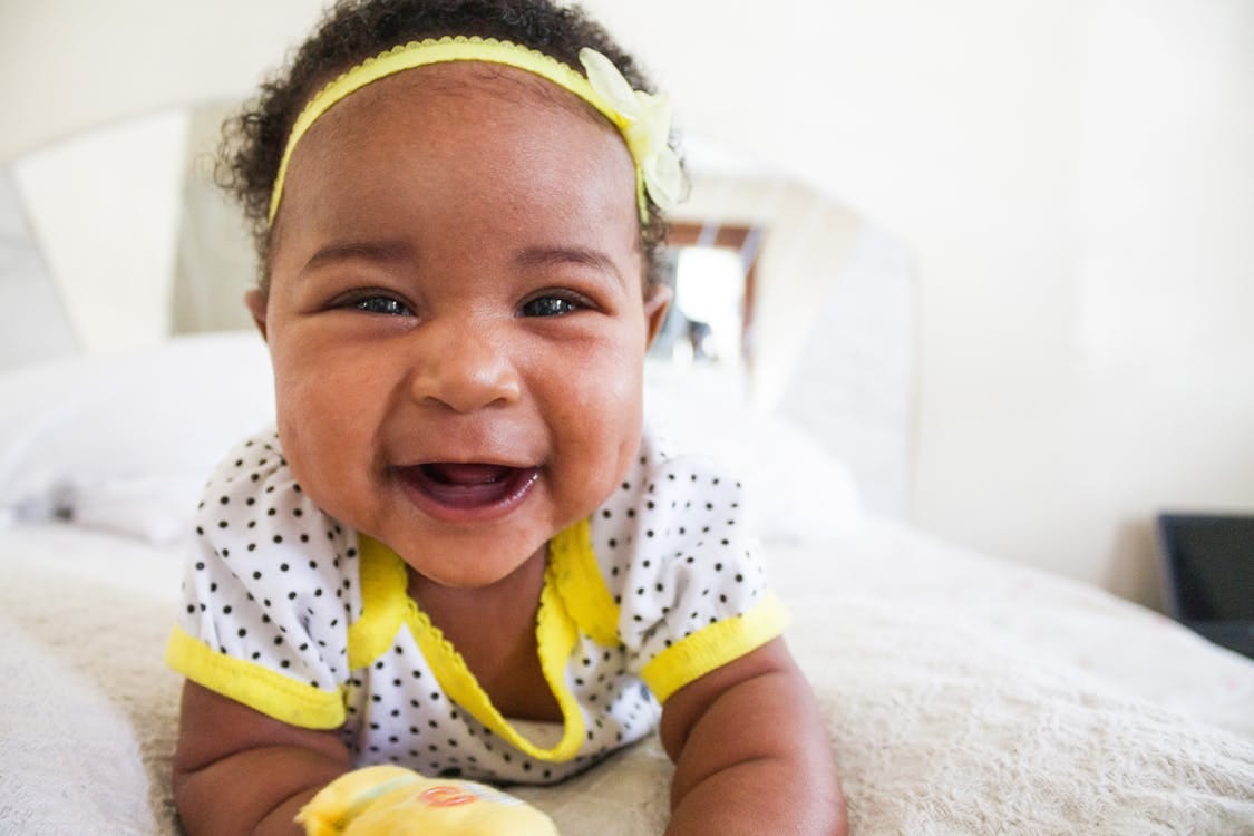 Free Baby Wearing White And Yellow Shirt Stock Photo