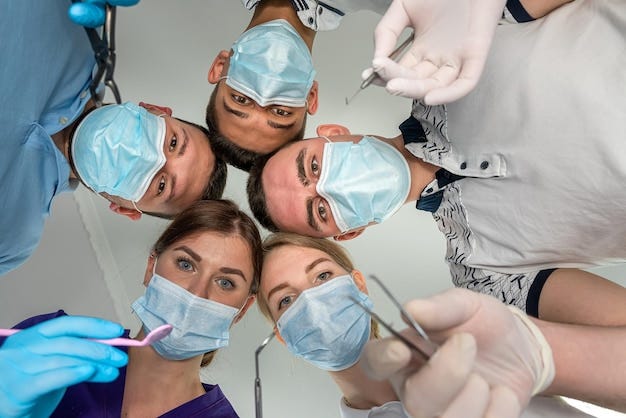 Premium Photo | Group of dentists holding medical instruments and stant in  a circle at a meeting Patient hospital