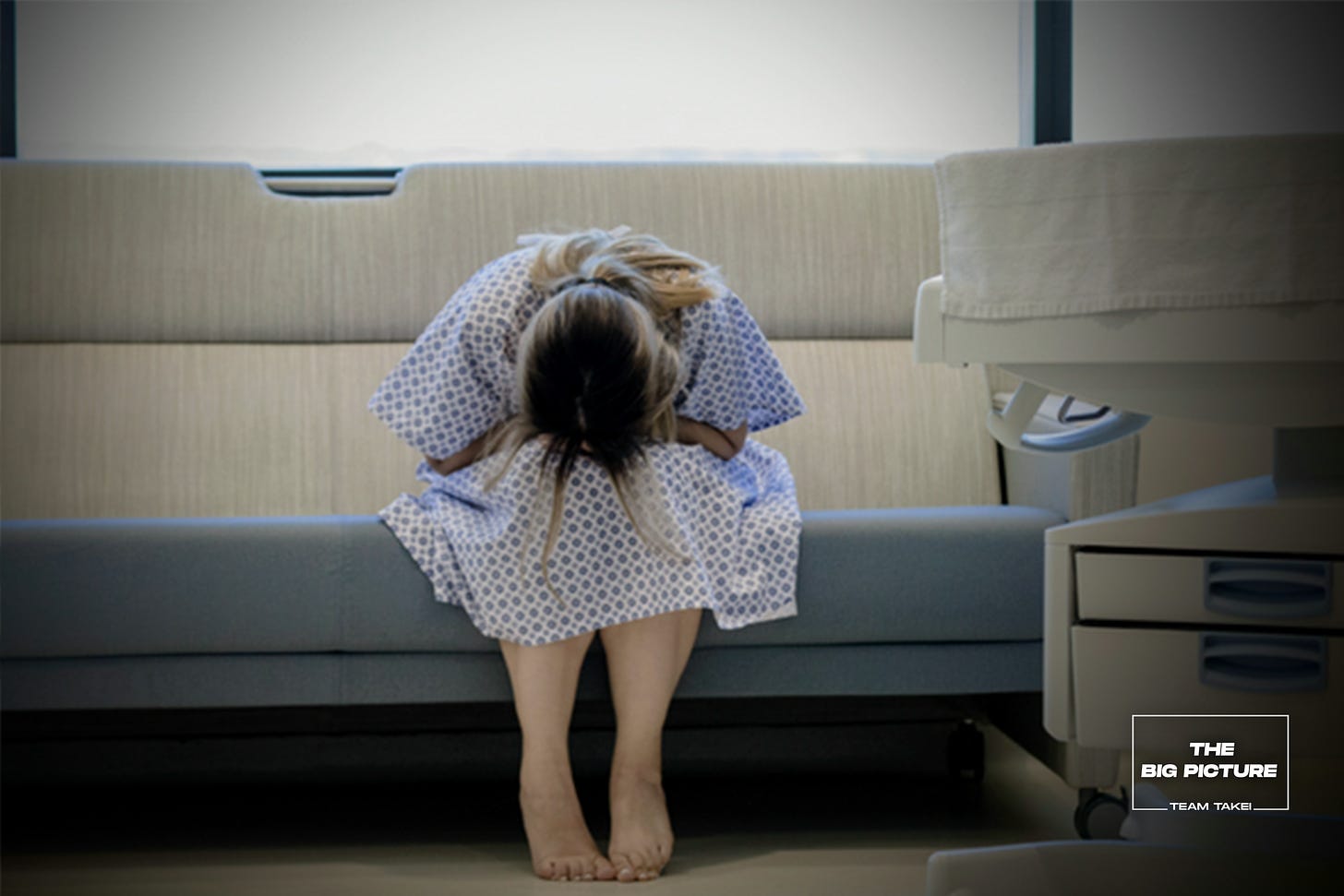 Young woman weeps in labor and delivery area of hospital